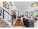 Open-concept living area showcasing a staircase and seamless transition into the dining and kitchen spaces, perfect for modern living at 5319 W Hoover Dr, Littleton, CO 80123