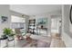 Comfortable living room featuring modern decor, a cozy chair, and plenty of natural light at 5319 W Hoover Dr, Littleton, CO 80123