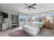 Bright main bedroom with a ceiling fan, large windows, and a comfortable seating area at 5319 W Hoover Dr, Littleton, CO 80123
