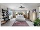 Bright main bedroom with a ceiling fan, large windows, and a comfortable seating area at 5319 W Hoover Dr, Littleton, CO 80123