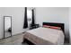 Cozy bedroom with wood-look floors, featuring modern furnishings, and large window with dark drapes at 21405 E 59Th Dr, Aurora, CO 80019