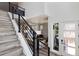 Inviting entryway with modern staircase, showcasing a bright and open floor plan at 21405 E 59Th Dr, Aurora, CO 80019