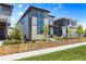 Contemporary home featuring a gated front yard, modern design and a combination of stone and siding under a blue sky at 21405 E 59Th Dr, Aurora, CO 80019