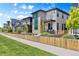 Attractive home with gated front yard, complemented by stylish stonework, clean lines and a modern balcony at 21405 E 59Th Dr, Aurora, CO 80019