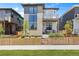 Charming two-story home with a mix of stone and siding and a cozy front porch and gated front yard at 21405 E 59Th Dr, Aurora, CO 80019