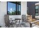 Close-up of a welcoming front porch with outdoor seating, offering a relaxing space to enjoy the neighborhood at 21405 E 59Th Dr, Aurora, CO 80019