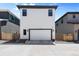Front exterior of a modern home featuring a spacious two-car garage at 21405 E 59Th Dr, Aurora, CO 80019