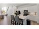 Modern kitchen featuring an island with bar stools and views to the living area at 21405 E 59Th Dr, Aurora, CO 80019