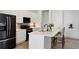 Well-lit kitchen features modern appliances and island with barstool seating at 21405 E 59Th Dr, Aurora, CO 80019
