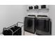 Well-equipped laundry room with modern washer, dryer and storage baskets at 21405 E 59Th Dr, Aurora, CO 80019