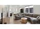 Spacious living room with a large sectional sofa and stylish round coffee table at 21405 E 59Th Dr, Aurora, CO 80019