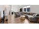 Spacious living room with comfortable sofa, hardwood floors, and plenty of natural light at 21405 E 59Th Dr, Aurora, CO 80019