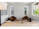 Bright living room featuring modern décor, plush seating and plenty of natural light from large windows at 21405 E 59Th Dr, Aurora, CO 80019