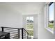 Bright staircase with modern railings and large windows offering neighborhood views at 21405 E 59Th Dr, Aurora, CO 80019