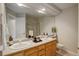 Well-lit bathroom with double sinks, a large mirror, and neutral colors at 9815 Raleigh St, Westminster, CO 80031