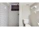 Updated bathroom featuring subway tile in the shower, modern fixtures, and toilet at 3075 Fairfax St, Denver, CO 80207