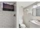 Updated bathroom featuring subway tile in the shower, modern fixtures, and toilet at 3075 Fairfax St, Denver, CO 80207
