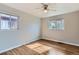 Bedroom with hardwood floors, two windows, ceiling fan, and neutral paint at 3075 Fairfax St, Denver, CO 80207