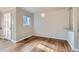Sunlit dining area featuring hardwood floors, neutral walls, and adjacent kitchen access at 3075 Fairfax St, Denver, CO 80207