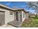 Charming front door on a gray brick house with landscaped garden and attached garage at 3075 Fairfax St, Denver, CO 80207