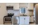 A modern kitchen featuring stainless steel appliances and white cabinets at 3075 Fairfax St, Denver, CO 80207