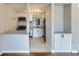 Open concept kitchen with white cabinets and stainless steel appliances at 3075 Fairfax St, Denver, CO 80207