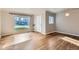 Light-filled living room features gleaming hardwood floors and a large picture window at 3075 Fairfax St, Denver, CO 80207