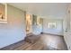 Spacious sun room with wood-look vinyl flooring and views into an updated kitchen at 3075 Fairfax St, Denver, CO 80207