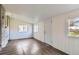Spacious sun room with wood-look vinyl flooring, white wood panel walls, and natural light at 3075 Fairfax St, Denver, CO 80207