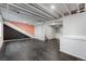 Finished basement with dark tile flooring, white walls, and painted accent wall at 8237 W 54Th Ave # 2, Arvada, CO 80002