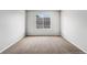 Bright bedroom featuring neutral walls, plush carpet, and a large window at 8237 W 54Th Ave # 2, Arvada, CO 80002