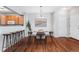 Bright dining area featuring hardwood floors, modern lighting, and views of the kitchen at 8237 W 54Th Ave # 2, Arvada, CO 80002