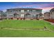 Inviting multi-Gathering exterior with manicured lawn, brick accents, and beautiful landscaping at 8237 W 54Th Ave # 2, Arvada, CO 80002