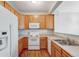 Efficient kitchen with ample cabinetry, white appliances, and durable countertops at 8237 W 54Th Ave # 2, Arvada, CO 80002