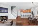 Open-concept living area with a fireplace, sleek bar stools, and staircase at 8237 W 54Th Ave # 2, Arvada, CO 80002