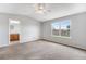 Spacious main bedroom features plush carpet, ceiling fan, and a bright window at 8237 W 54Th Ave # 2, Arvada, CO 80002