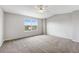 Spacious main bedroom features plush carpet, ceiling fan, and a bright window at 8237 W 54Th Ave # 2, Arvada, CO 80002