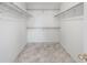 Spacious walk-in closet with installed shelving and attractive marble-style flooring at 8237 W 54Th Ave # 2, Arvada, CO 80002