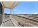Balcony overlooking a roadway with distant fields under a clear, sunny sky at 17717 E 54Th Ave, Denver, CO 80249