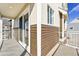 Balcony with brown siding and white railings, offering a view of the neighborhood at 17717 E 54Th Ave, Denver, CO 80249