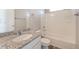 Bathroom featuring granite countertop vanity, a white tub and shower combo with tiled walls at 17717 E 54Th Ave, Denver, CO 80249