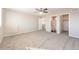 Bright bedroom with a ceiling fan, ensuite bath, and walk-in closet at 17717 E 54Th Ave, Denver, CO 80249