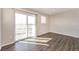 Bright bedroom with large sliding glass door and wood-look flooring at 17717 E 54Th Ave, Denver, CO 80249