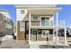 Two-story home with a charming balcony, green door, and neutral-tone siding at 17717 E 54Th Ave, Denver, CO 80249