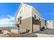 Exterior showing a two-story home with a balcony, garage, and a white picket fence at 17717 E 54Th Ave, Denver, CO 80249