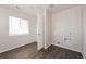 Room showcasing hard flooring, a window with blinds, and in-wall utility hookups at 17717 E 54Th Ave, Denver, CO 80249
