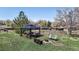 Large backyard offering multiple seating options including a gazebo and outdoor fire pit at 381 S Estes St # 1, Lakewood, CO 80226