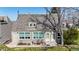 Inviting two-story home featuring manicured landscaping and a cozy front entrance with seating area at 381 S Estes St # 1, Lakewood, CO 80226