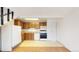 Efficient kitchen with neutral countertops, white appliances, and wood cabinets adjacent to living area at 381 S Estes St # 1, Lakewood, CO 80226