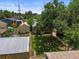 Overhead view of a backyard with sheds, garden plots, a greenhouse, and mature tree at 3306 S Logan St, Englewood, CO 80113